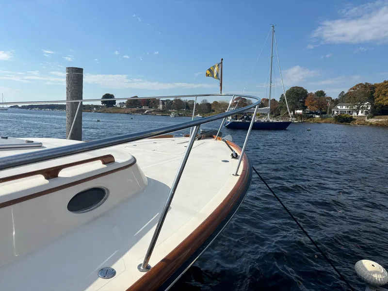 Slide: The Image of 2005 Hinckley Talaria 44 MY yacht docked on a sunny day, with scenic waterfront view. - 4
