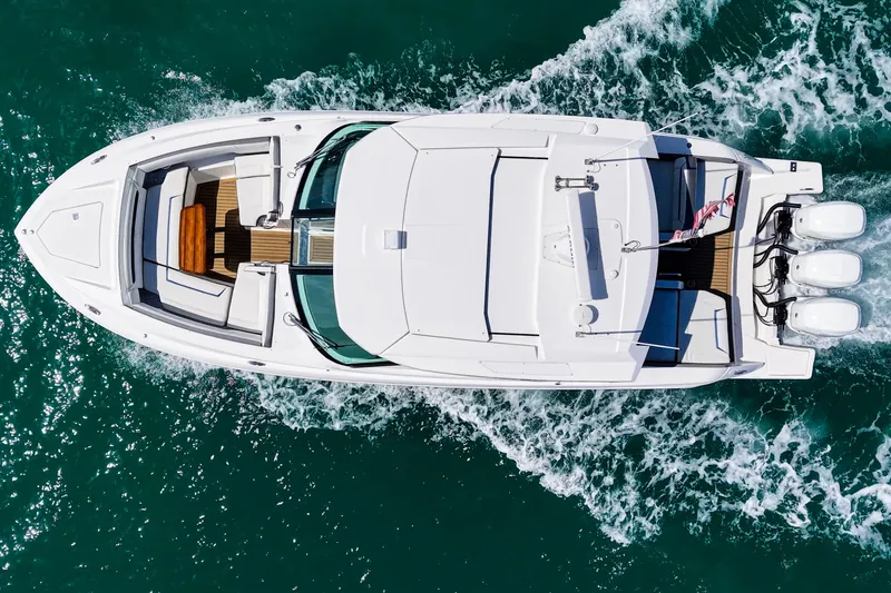 Slide: The Image of Aerial view of 2022 Tiara Yachts 38 LX cruising on turquoise water. - 10