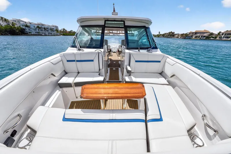 Slide: The Image of 2022 Tiara Yachts 38 LX with luxurious seating on a serene water backdrop. - 14