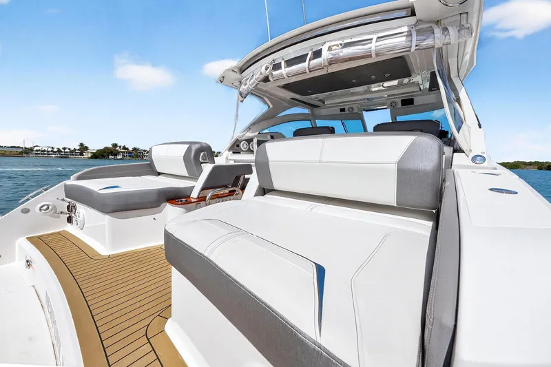 Slide: The Image of 2022 Tiara Yachts 38 LX luxury boat with sleek seating and modern design on open water. - 21