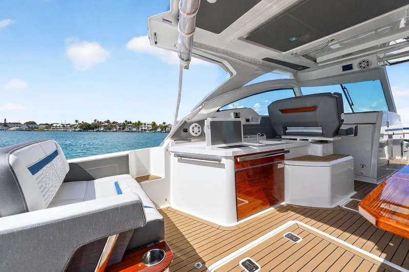 Slide: The Image of 2022 Tiara Yachts 38 LX interior with luxurious seating and modern amenities on open water. - 22
