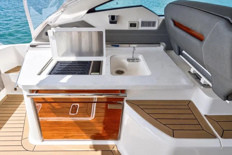Slide: The Image of 2022 Tiara Yachts 38 LX boat interior with sink and grill station. - 23