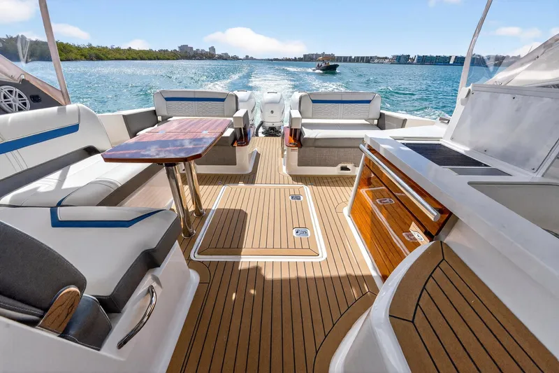 Slide: The Image of 2022 Tiara Yachts 38 LX interior with luxurious seating and wooden deck on open water. - 24