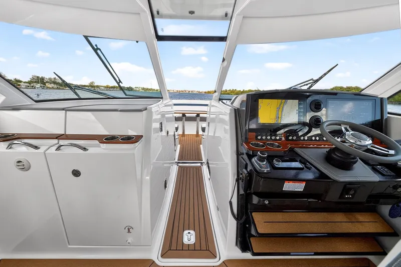 Slide: The Image of 2022 Tiara Yachts 38 LX helm with modern navigation system and sleek interior design. - 26