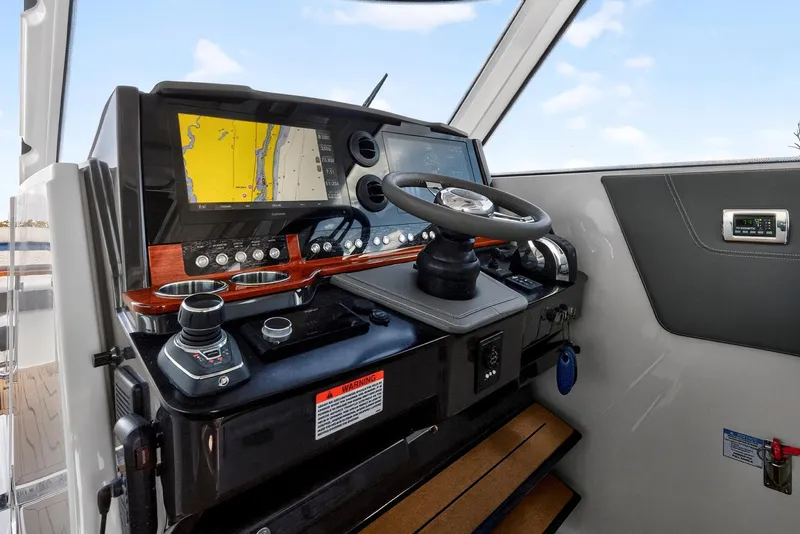 Slide: The Image of 2022 Tiara Yachts 38 LX helm with navigation display and controls. - 27