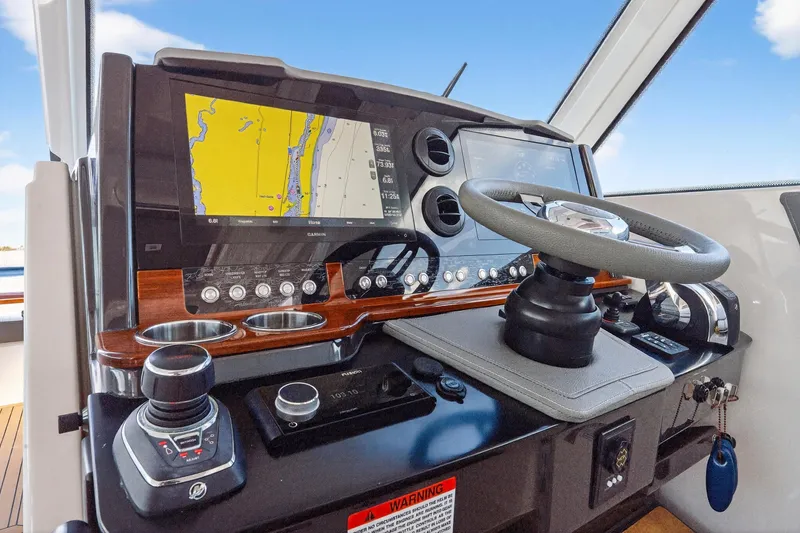 Slide: The Image of 2022 Tiara Yachts 38 LX helm with advanced navigation and control systems. - 28