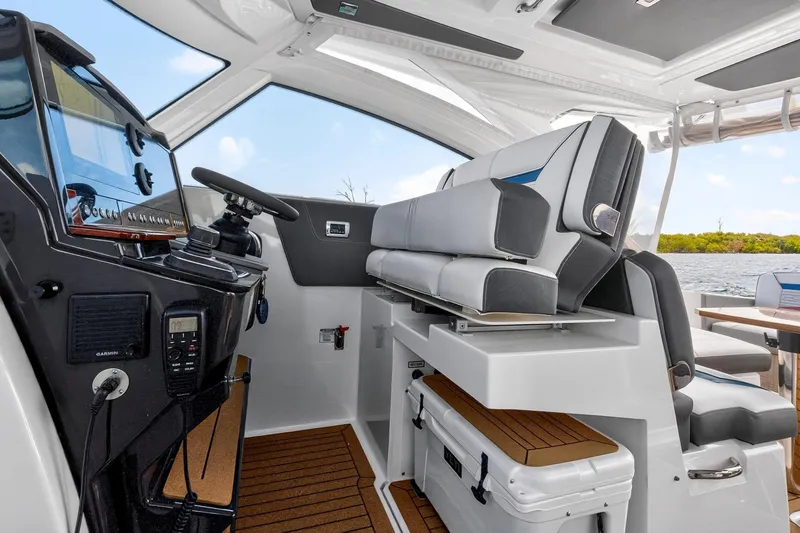 Slide: The Image of 2022 Tiara Yachts 38 LX interior with helm, seating, and navigation equipment. - 30