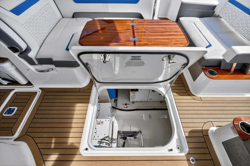 Slide: The Image of 2022 Tiara Yachts 38 LX interior with open hatch, showcasing sleek seating and wood accents. - 32