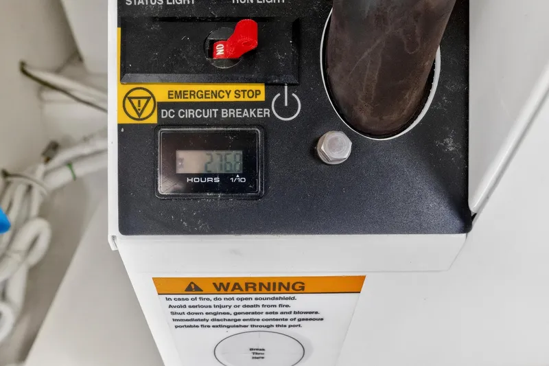 Slide: The Image of Tiara Yachts 38 LX 2022 control panel with emergency stop and hour meter. - 33