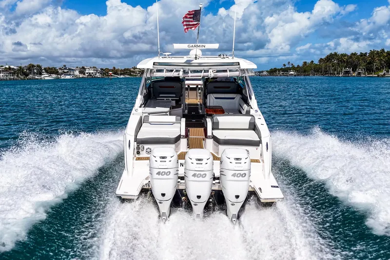 Slide: The Image of 2022 Tiara Yachts 38 LX cruising on blue water with triple 400 engines. - 4