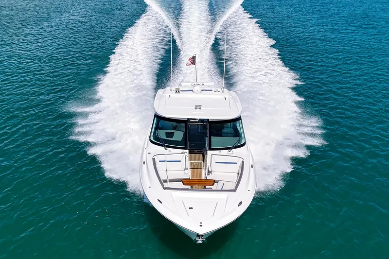 Slide: The Image of 2022 Tiara Yachts 38 LX cruising on clear blue water, aerial view. - 6