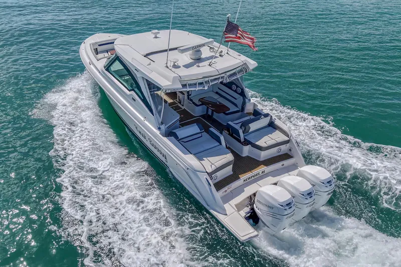 Slide: The Image of 2022 Tiara Yachts 38 LX cruising on clear blue water with American flag. - 7