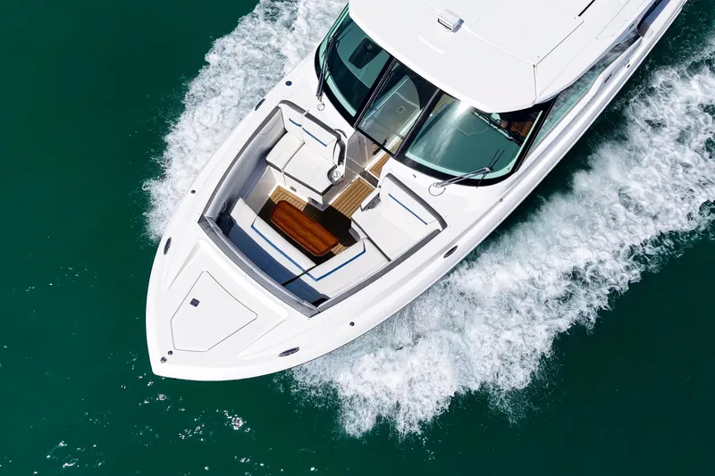 Slide: The Image of 2022 Tiara Yachts 38 LX cruising on clear blue water, aerial view. - 8