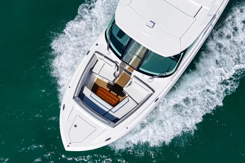 Slide: The Image of 2022 Tiara Yachts 38 LX cruising on clear turquoise water, aerial view. - 9