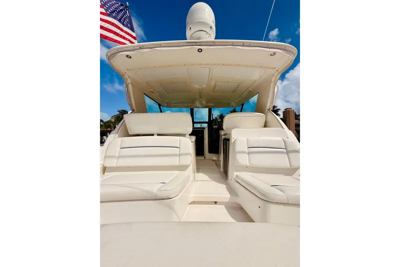 Slide: The Image of 2005 Tiara Yachts 3600 Sovran with spacious seating, under a clear blue sky. - 13