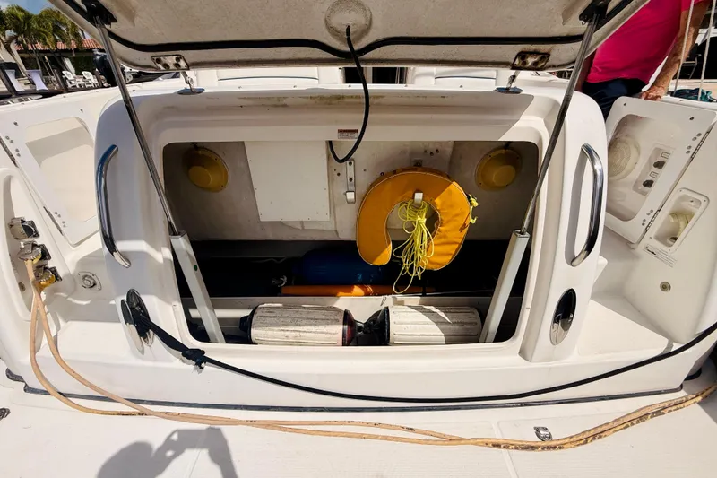 Slide: The Image of Open storage compartment on 2005 Tiara Yachts 3600 Sovran with life preserver and equipment. - 14