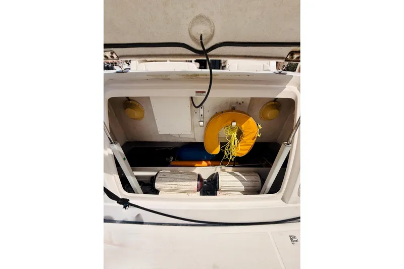 Slide: The Image of 2005 Tiara Yachts 3600 Sovran storage compartment with life preserver and equipment. - 15