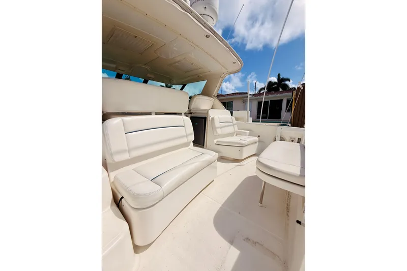 Slide: The Image of 2005 Tiara Yachts 3600 Sovran interior with white seating and open deck under blue sky. - 16
