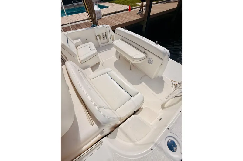 Slide: The Image of 2005 Tiara Yachts 3600 Sovran cockpit with white seating and dock view. - 19