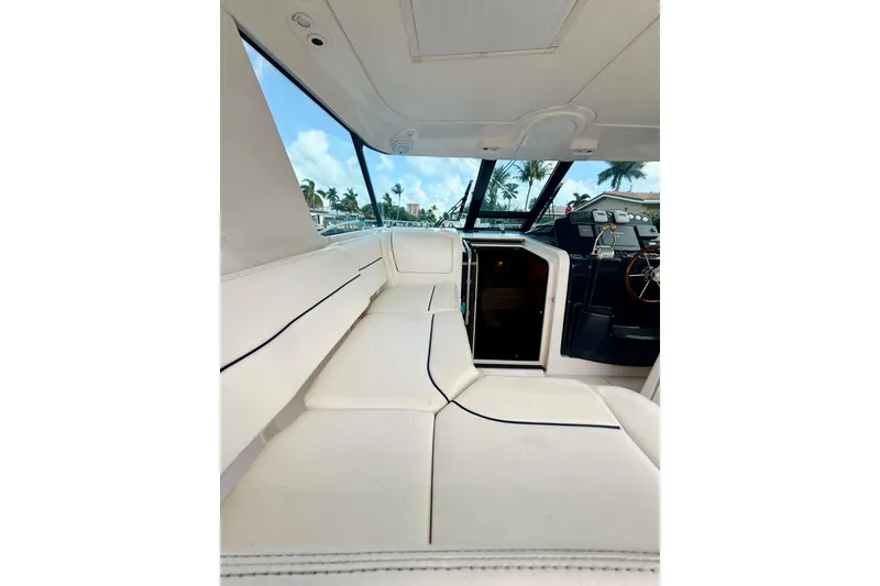 Slide: The Image of 2005 Tiara Yachts 3600 Sovran interior with white seating and helm view. - 23