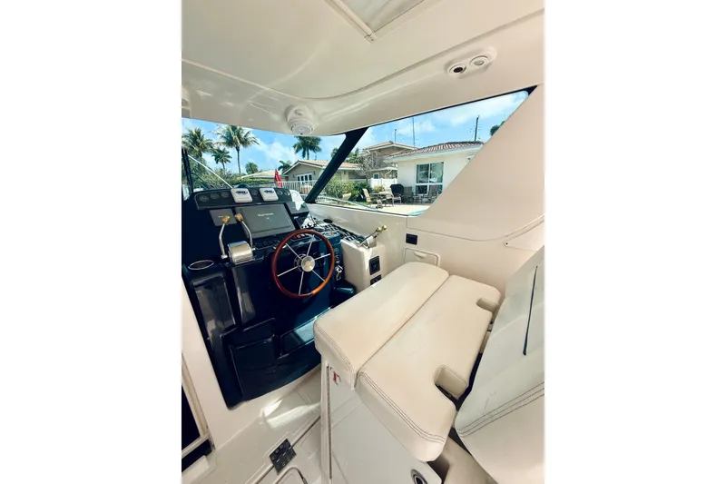 Slide: The Image of 2005 Tiara Yachts 3600 Sovran helm with steering wheel and navigation controls. - 27
