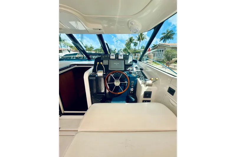 Slide: The Image of 2005 Tiara Yachts 3600 Sovran helm with wooden steering wheel and modern controls. - 28
