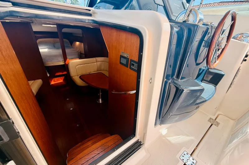Slide: The Image of 2005 Tiara Yachts 3600 Sovran interior with wood accents and cozy seating area. - 32