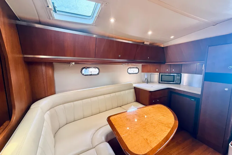 Slide: The Image of Luxurious interior of 2005 Tiara Yachts 3600 Sovran with elegant seating and kitchenette. - 36