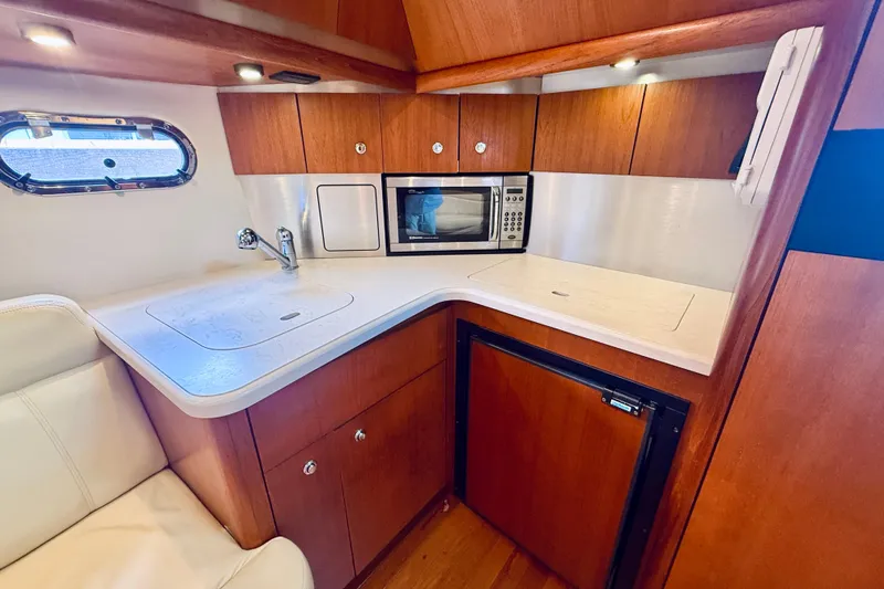 Slide: The Image of Luxurious 2005 Tiara Yachts 3600 Sovran galley with wood cabinetry and modern appliances. - 38