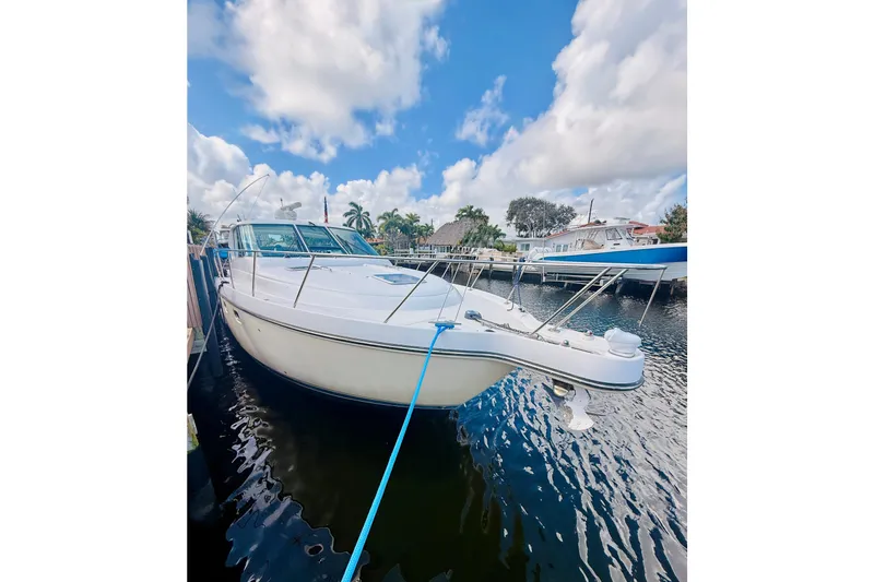 Slide: The Image of 2005 Tiara Yachts 3600 Sovran docked, under a bright blue sky with clouds. - 4