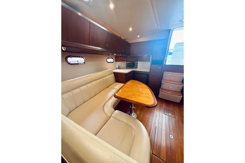 Slide: The Image of Luxurious interior of 2005 Tiara Yachts 3600 Sovran with leather seating and wooden table. - 41
