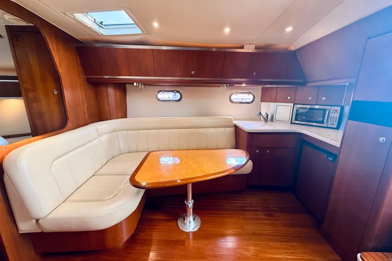 Slide: The Image of Luxurious 2005 Tiara Yachts 3600 Sovran interior with elegant dining area and kitchenette. - 43