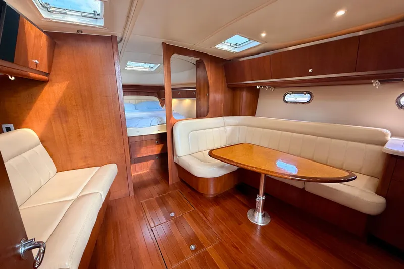 Slide: The Image of 2005 Tiara Yachts 3600 Sovran interior with wood finish and cozy seating area. - 49