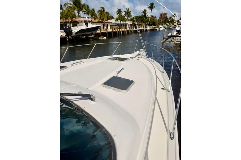 Slide: The Image of 2005 Tiara Yachts 3600 Sovran docked by palm trees and waterfront homes. - 51