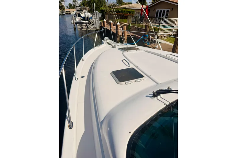 Slide: The Image of 2005 Tiara Yachts 3600 Sovran docked, showcasing sleek deck design and waterfront setting. - 53