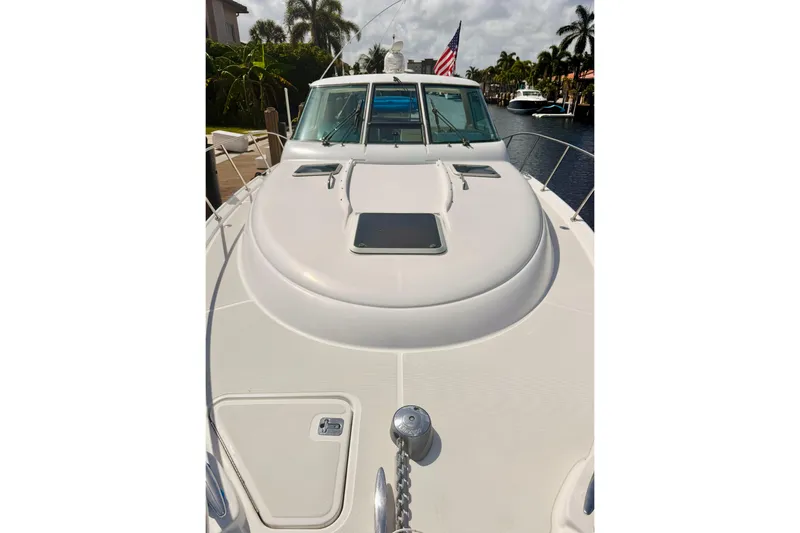 Slide: The Image of 2005 Tiara Yachts 3600 Sovran boat deck with American flag, docked in a canal. - 56