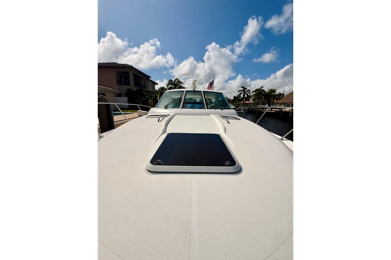 Slide: The Image of 2005 Tiara Yachts 3600 Sovran on water, sunny day, palm trees in background. - 57