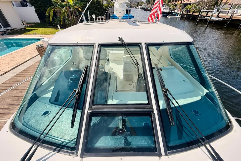 Slide: The Image of 2005 Tiara Yachts 3600 Sovran docked, showcasing cockpit and windshield design. - 60