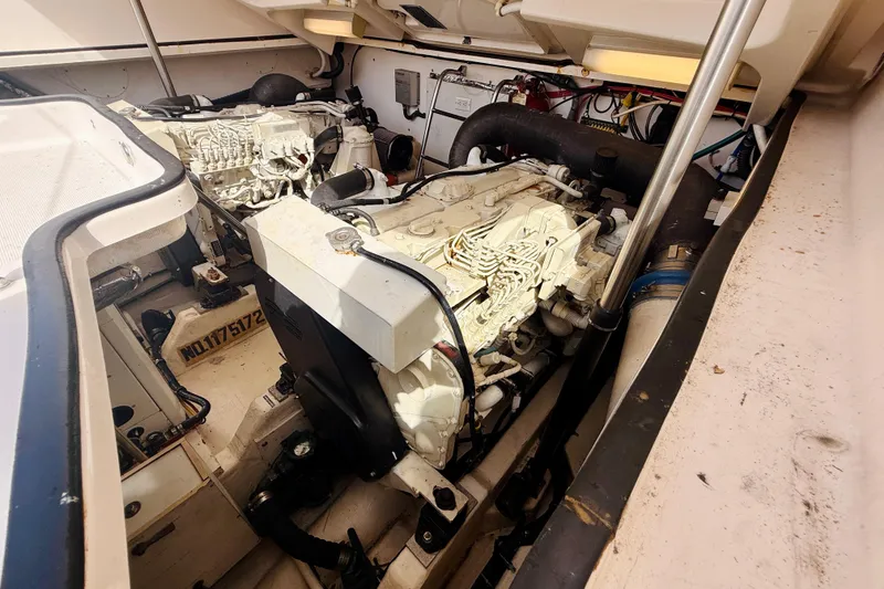 Slide: The Image of Engine compartment of a 2005 Tiara Yachts 3600 Sovran, showcasing dual engines and mechanical components. - 66
