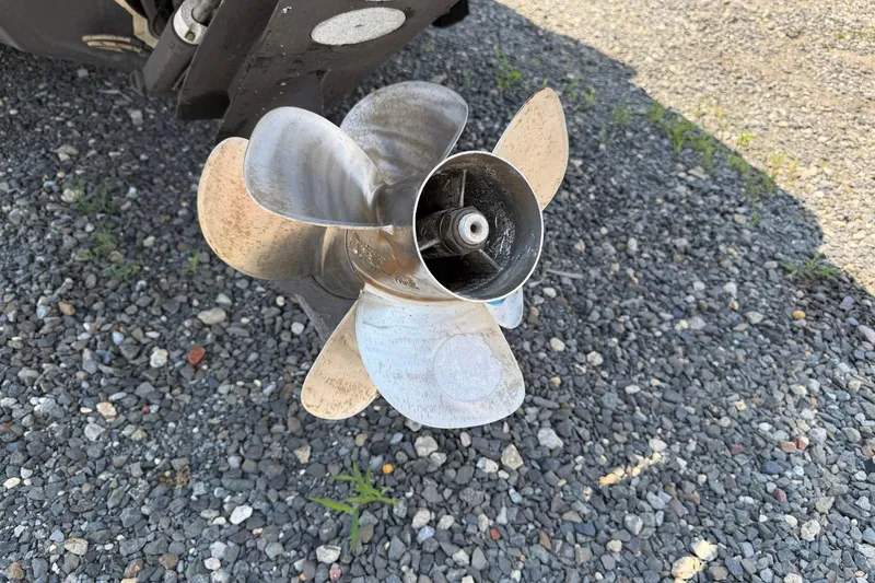 Slide: The Image of Propeller of 2014 Sea Ray 240 Sundeck Outboard on gravel surface. - 16
