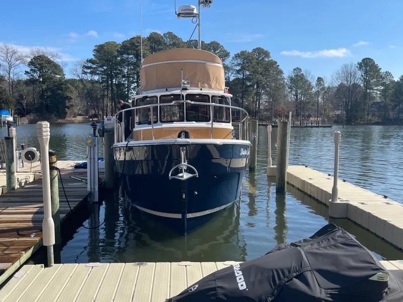 The Image of 2022 Ranger Tugs R-31 CB docked at a serene pier. - 0