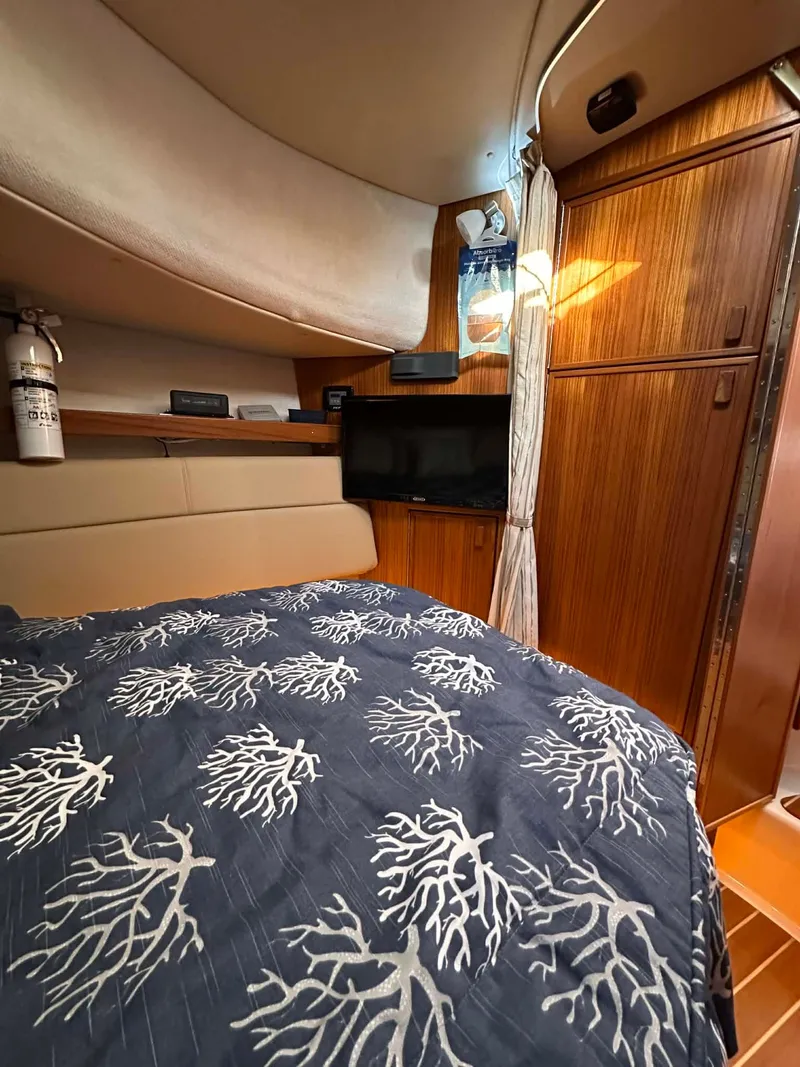 Slide: The Image of Interior of 2022 Ranger Tugs R-31 CB with bed and wooden cabinetry. - 11