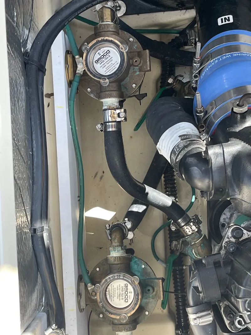 Slide: The Image of Engine compartment of 2022 Ranger Tugs R-31 CB with hoses and valves. - 13