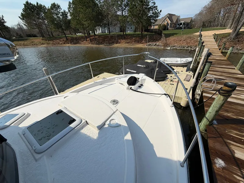 Slide: The Image of 2022 Ranger Tugs R-31 CB docked, surrounded by water and trees. - 20