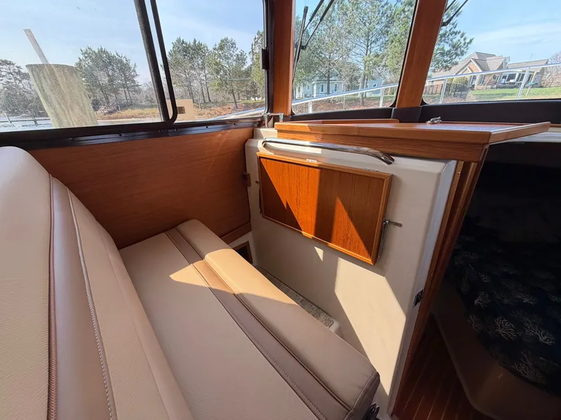 Slide: The Image of Interior of 2022 Ranger Tugs R-31 CB with beige seating and wood accents. - 26