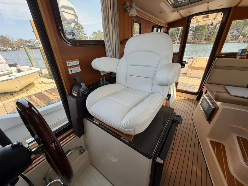Slide: The Image of Interior of 2022 Ranger Tugs R-31 CB with white captain's chair. - 28