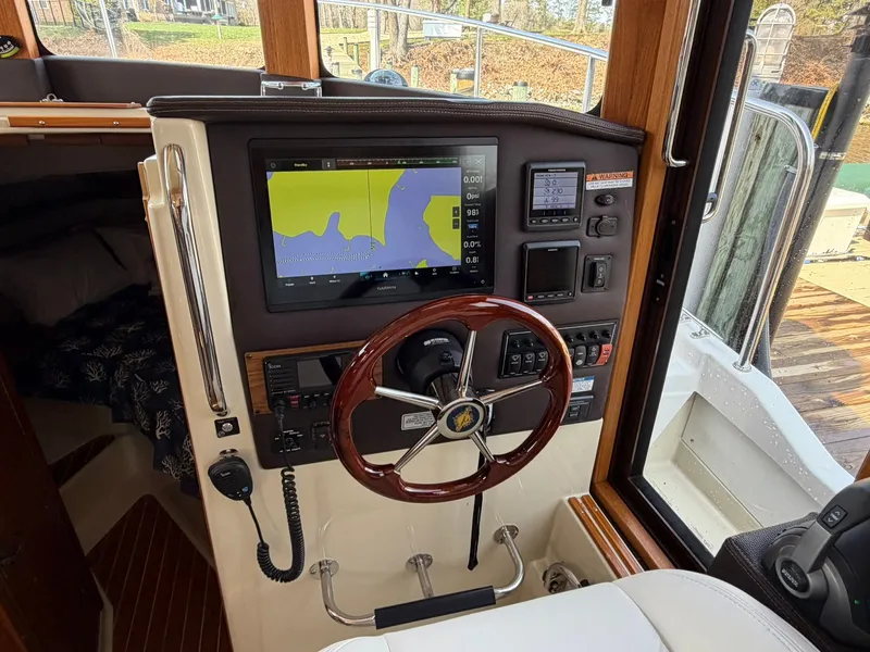 Slide: The Image of Interior view of the helm station on a 2022 Ranger Tugs R-31 CB. - 32
