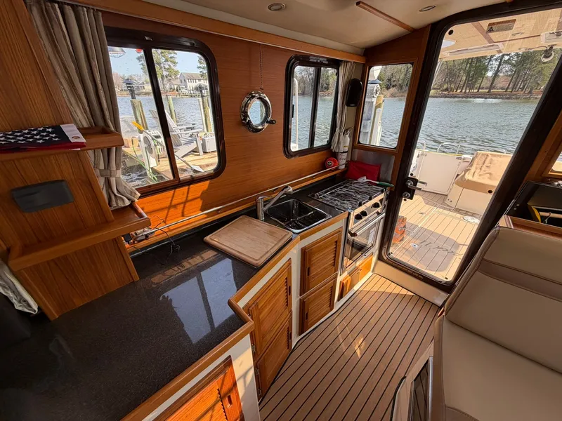Slide: The Image of Interior of 2022 Ranger Tugs R-31 CB yacht with kitchen and lake view. - 35