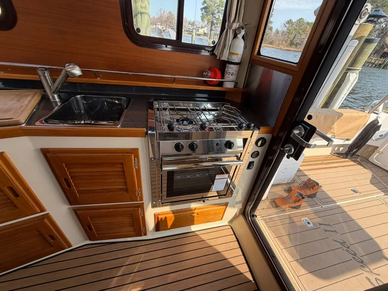 Slide: The Image of Interior of 2022 Ranger Tugs R-31 CB with kitchen and stove. - 36