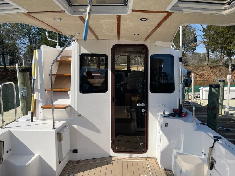 Slide: The Image of Ranger Tugs R-31 CB 2022, boat stern with stairs and door. - 4